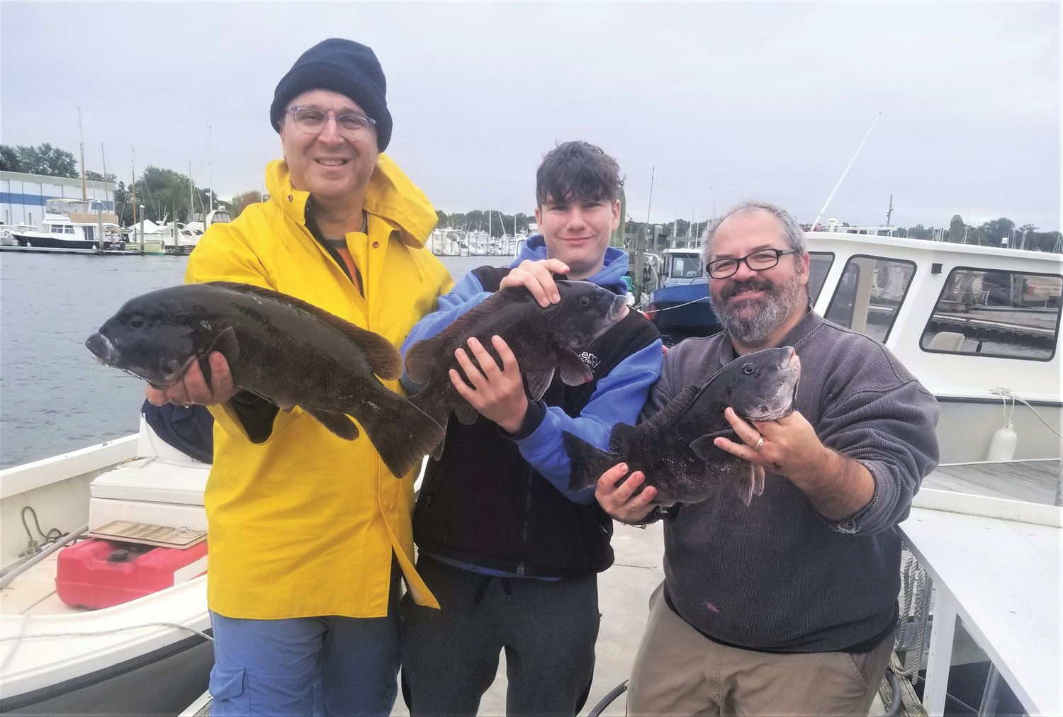 TAUTOG BITE VERY GOOD:  Steve Burstein of North Kingstown with Andrew Stevens and his father Jim Stevens of Warwick with some tautog brutes they caught Saturday at General Rock in North Kingstown.
